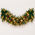 Illuminated emerald green and gold Christmas garland concept with ribbon bows and coordinated ornament accents