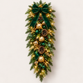 Illuminated emerald green and gold Christmas swag concept with a green ribbon bow and ornament accents
